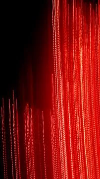 Red dotted lines of lights on a black background Stock Photos