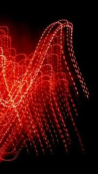 Red dotted lines of lights on a black background Stock Photos