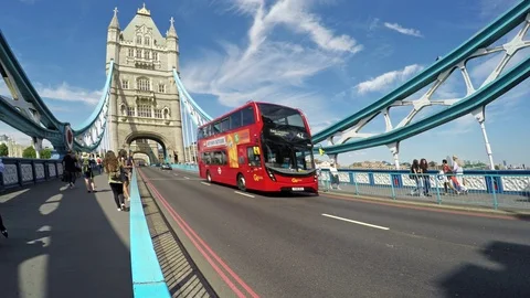 Red double-decker bus and tourists on Tower Bridge Stock Footage 79594675