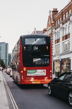 Red double decker bus and cars queuing in traffic on Tottenham Court Road, Lo Foto stock