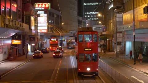 A Red Double-decker Bus Moving Forward On The Streets of Hong Kong at Night Stock Footage 144041602
