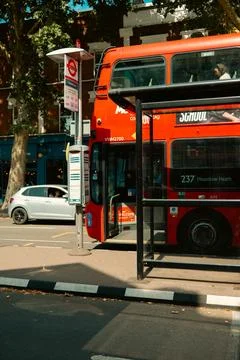 Red double-decker bus on route 237 to Hounslow Heath stopped at a bus stop .. Stock Photos