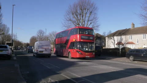 Red Double Decker Bus Rushing Through Residential Street During Daytime, London Stock-Footage 326356325