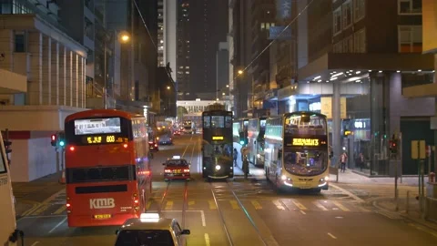 Red Double-decker Buses and Cars Pasing by On The Streets of Hong Kong at Night Stock Footage 144041714