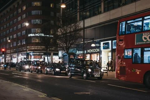 Red double decker buses and taxis on Oxford Street, London, UK, in the evenin Stock Photos