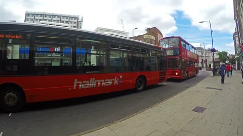 Red double-decker busses in a traffic jam on a street in London Stock Footage 79928451