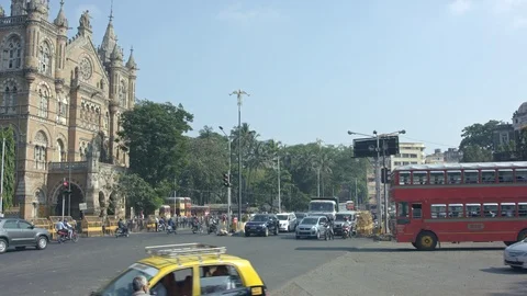 Red double-decker drives past the train station 스톡 동영상 90975166