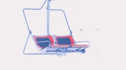 A red double empty chair lift is moving in a ski resort in winter. Stock Footage 101316665