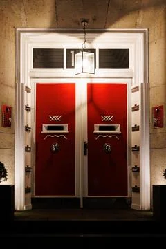 Red Double Front Doors with Lantern at Night Stock Photos