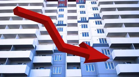 Red down arrow sign on background of new residential building. Rising price Stock Photos