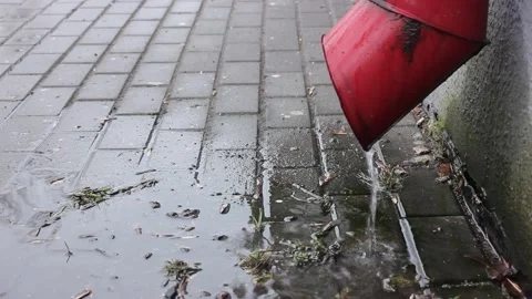 Red downpipe with water flow on a rainy day Видео 123893256