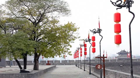 Red dragon flag along and Lantern in the top of Xian City Wall Stock Footage 974653