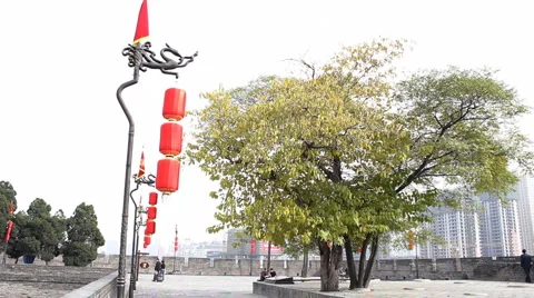 Red dragon flag along and Lantern in the top of Xian City Wall Stock Footage 975972
