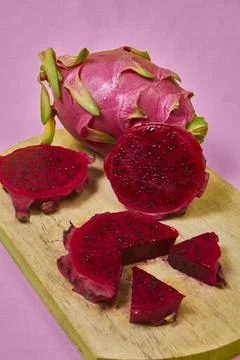 Red dragon fruit Set with appetizing serving on pink background. Top view Stock Photos