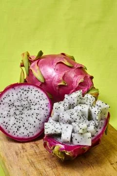 Red dragon fruit Set with appetizing serving on green background. Top view Stock Photos