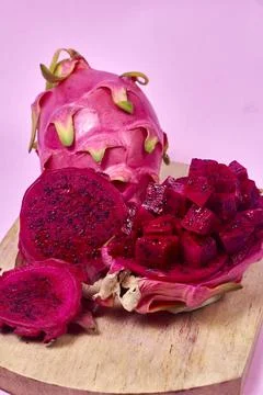 Red dragon fruit Set with appetizing serving on pink background. Top view Stock Photos