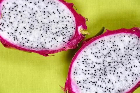Red dragon fruit Set with appetizing serving on green background. Top view Stock Photos