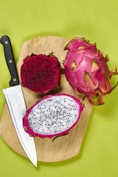 Red dragon fruit Set with appetizing serving on green background. Top view Stock Photos