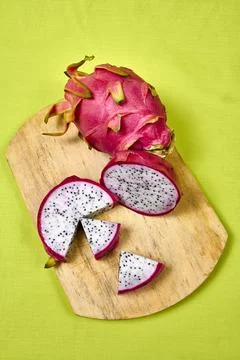 Red dragon fruit Set with appetizing serving on green background. Top view Stock Photos