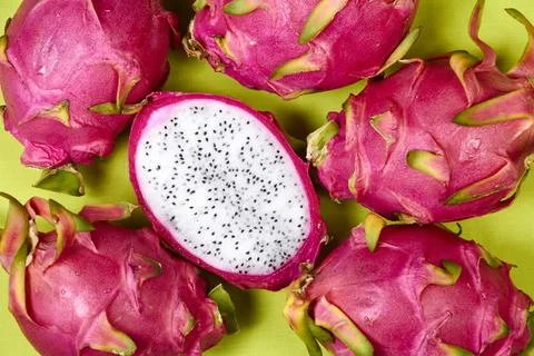 Red dragon fruit Set with appetizing serving on green background. Top view Stock Photos