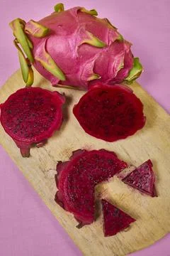 Red dragon fruit Set with appetizing serving on pink background. Top view Stock Photos