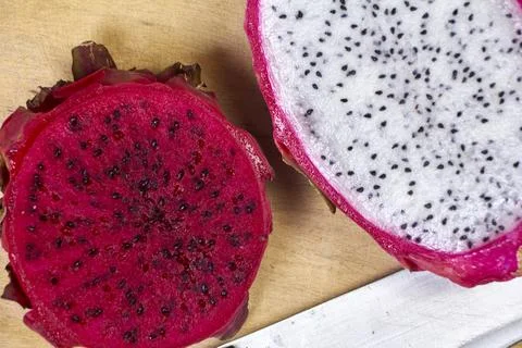Red dragon fruit Set with appetizing serving on green background. Top view Stock Photos