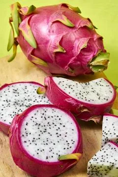 Red dragon fruit Set with appetizing serving on green background. Top view Stock Photos