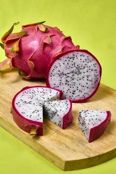 Red dragon fruit Set with appetizing serving on green background. Top view Stock Photos