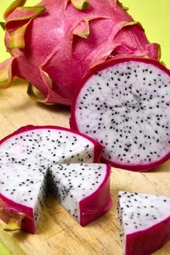 Red dragon fruit Set with appetizing serving on green background. Top view Stock Photos