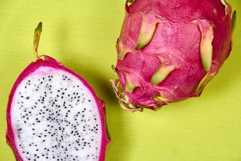 Red dragon fruit Set with appetizing serving on green background. Top view Stock Photos