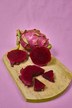 Red dragon fruit Set with appetizing serving on pink background. Top view Stock Photos