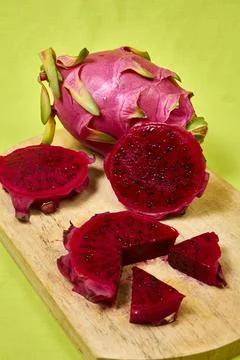 Red dragon fruit Set with appetizing serving on green background. Top view Stock Photos
