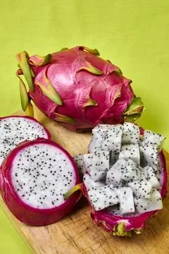 Red dragon fruit Set with appetizing serving on green background. Top view Stock Photos