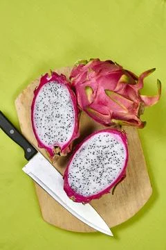 Red dragon fruit Set with appetizing serving on green background. Top view Stock Photos