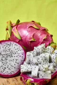 Red dragon fruit Set with appetizing serving on green background. Top view Stock Photos