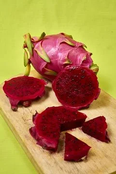 Red dragon fruit Set with appetizing serving on green background. Top view Stock Photos