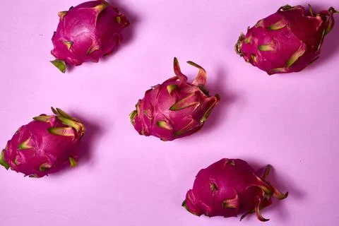 Red dragon fruit Set with appetizing serving on pink background. Top view Stock Photos