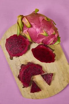 Red dragon fruit Set with appetizing serving on pink background. Top view Stock Photos