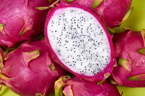 Red dragon fruit Set with appetizing serving on green background. Top view Stock Photos