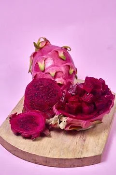 Red dragon fruit Set with appetizing serving on pink background. Top view Stock Photos