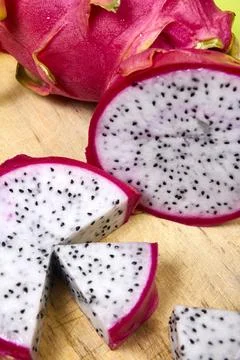 Red dragon fruit Set with appetizing serving on green background. Top view Stock Photos