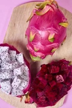 Red dragon fruit Set with appetizing serving on pink background. Top view Stock Photos