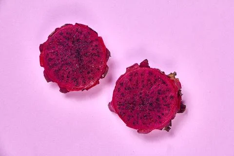 Red dragon fruit Set with appetizing serving on pink background. Top view Stock Photos