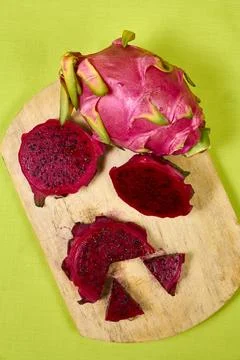 Red dragon fruit Set with appetizing serving on green background. Top view Stock Photos
