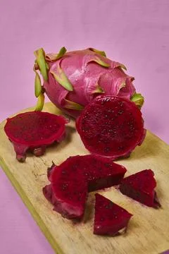 Red dragon fruit Set with appetizing serving on pink background. Top view Stock Photos