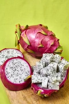 Red dragon fruit Set with appetizing serving on green background. Top view Stock Photos