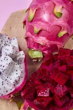 Red dragon fruit Set with appetizing serving on pink background. Top view Stock Photos