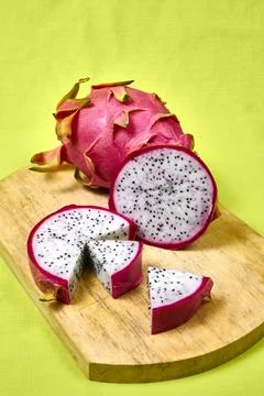 Red dragon fruit Set with appetizing serving on green background. Top view Stock Photos