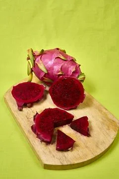 Red dragon fruit Set with appetizing serving on green background. Top view Stock Photos