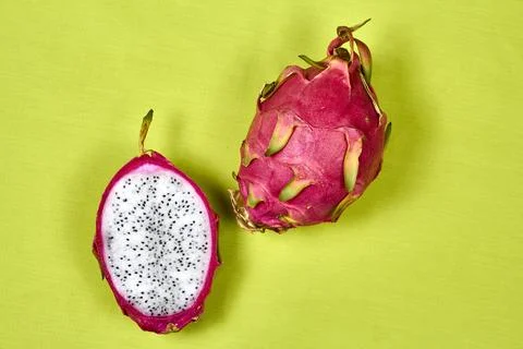 Red dragon fruit Set with appetizing serving on green background. Top view Stock Photos